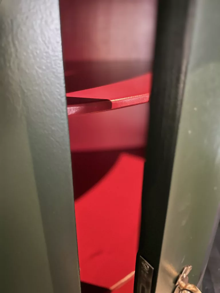 Blick durch die geöffnete Tür auf die roten Einlegeböden